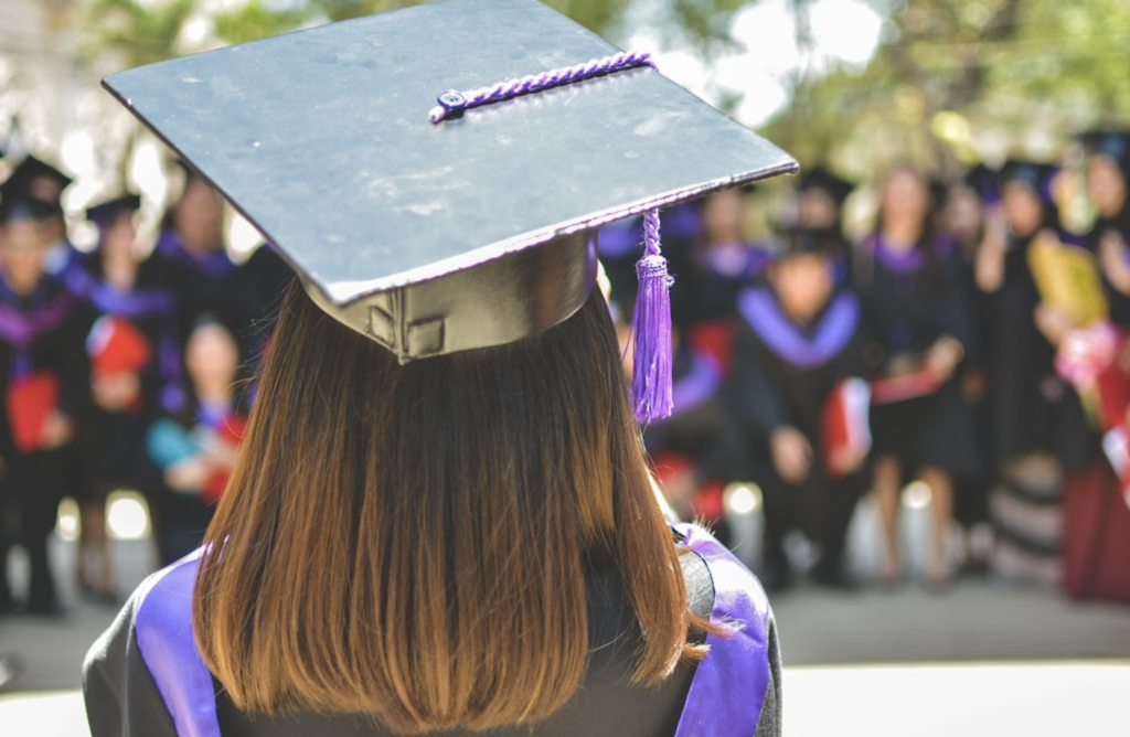 student in cap and gown at graduation