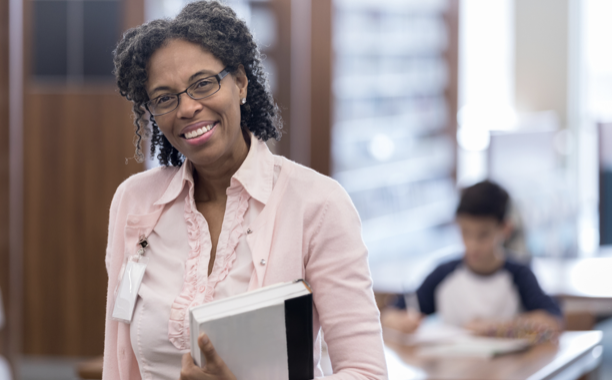 Woman smiling and holding book