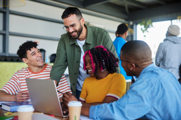 people gathered around a laptop 